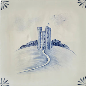 Tile with a blue castle design on a white background