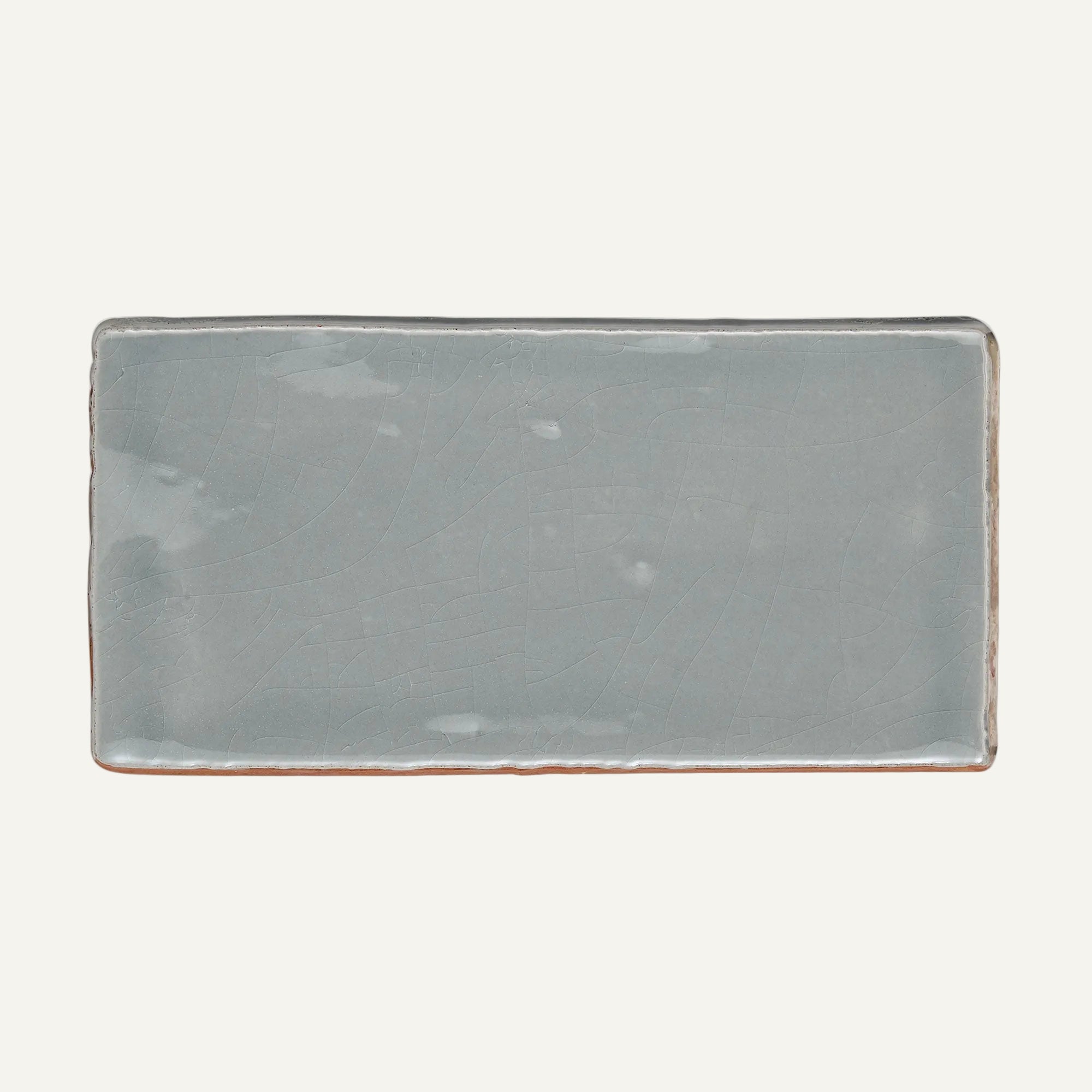 Rectangular ceramic plate with a grayish-blue finish on a white background