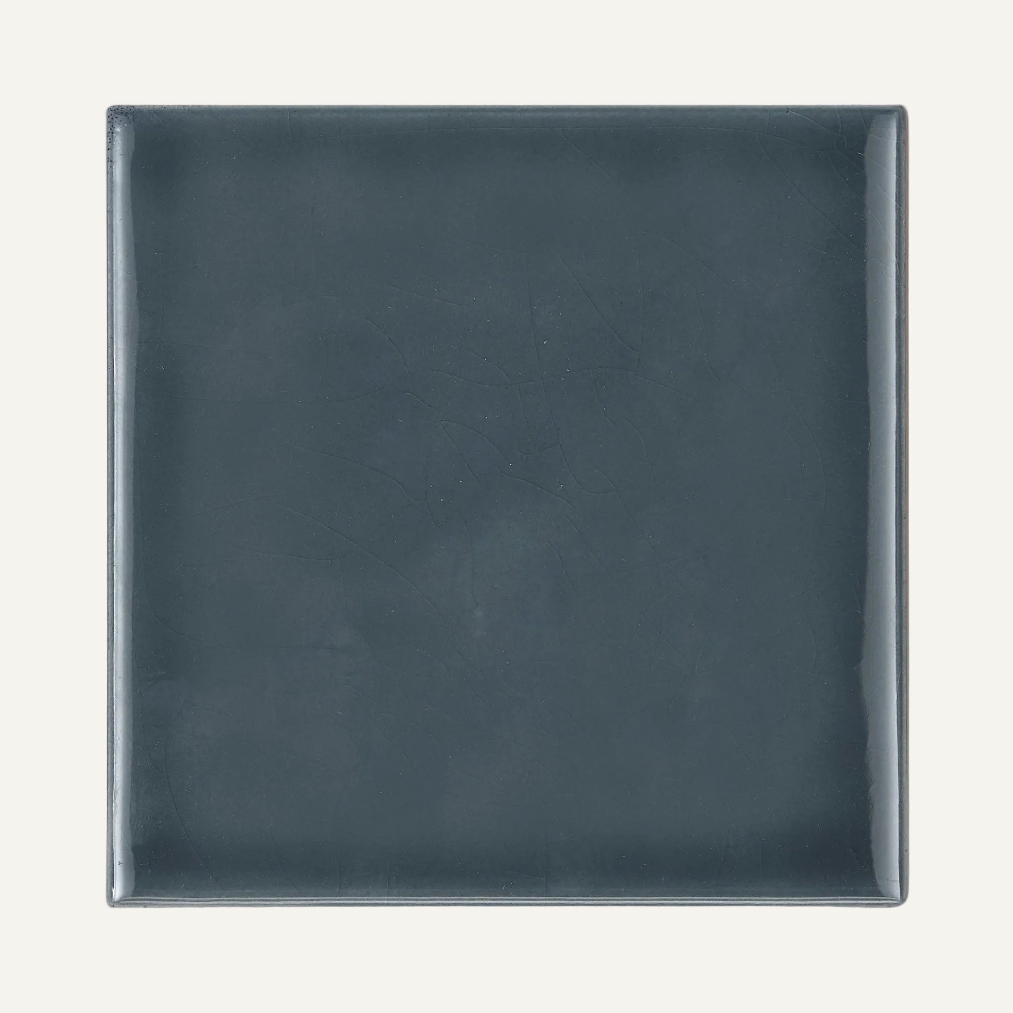 Dark gray square plate on a white background