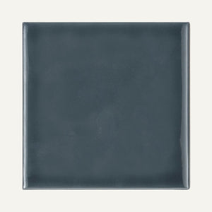 Dark gray square plate on a white background